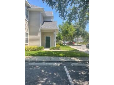 Inviting home exterior featuring a well-maintained lawn and assigned parking spaces at 417 Southern Pecan Cir # 201, Winter Garden, FL 34787