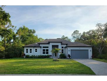 Beautiful single-story home boasts a manicured lawn, neutral paint, and an attached two car garage at 4528 Yorkshire Ln, Kissimmee, FL 34758