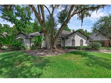 Charming single-story home featuring stucco exterior, mature landscaping, and a well-manicured lawn at 460 W Palm Valley Dr, Oviedo, FL 32765