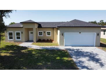 Charming single-Gathering home with well-maintained lawn, gray roof, and attached two-car garage at 6741 Heavitree Dr, Sebring, FL 33876