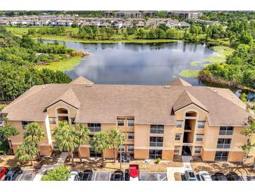 Charming condo building with well-maintained landscaping, palm trees, and convenient parking spaces at 8801 Latrec Ave # 8101, Orlando, FL 32819