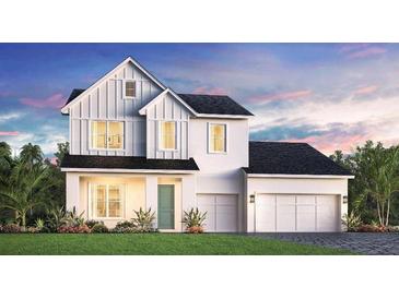 Charming two-story home featuring a clean white facade, a two-car garage, and lush landscaping at 1012 Gloryland Ct, Sanford, FL 32771