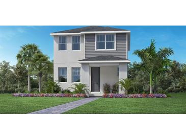 Beautiful two-story home with a landscaped yard, gray siding and stucco exterior at 1438 Ridgeback Ln, Apopka, FL 32703