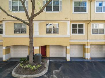 Two-story condo with a garage and a red front door at 1810 Shadow View Cir # 1810, Maitland, FL 32751
