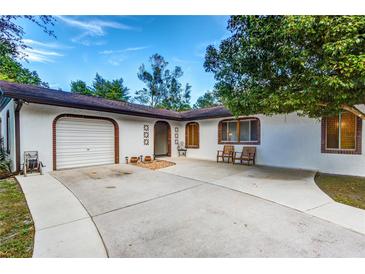 Welcoming single-story home boasts a brick-accented facade and a convenient attached garage at 205 Elaine Pl, Chuluota, FL 32766