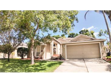 Charming single Gathering home featuring a well maintained lawn and a two car garage at 2343 Walnut Heights Rd, Apopka, FL 32703