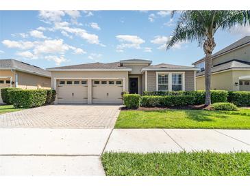 Charming single-story home featuring a well-manicured lawn and a two-car garage at 4737 Maple Park St, Orlando, FL 32811
