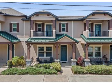 Charming townhouse featuring a cozy front porch and beautiful landscaping at 5119 Jones Rd, St Cloud, FL 34771