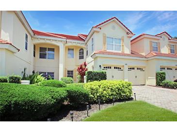 Beautiful home featuring a tile roof, a two car garage, and immaculate landscaping at 6941 Piazza St, Orlando, FL 32819