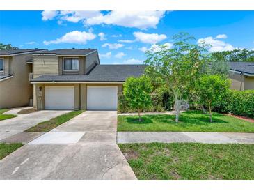 Charming townhome with two-car garage and well-manicured front lawn, perfect for suburban living at 8248 Limetree Ct, Orlando, FL 32836