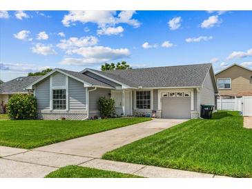 Charming single-story home with well-maintained lawn, mature landscaping, and covered entryway at 9447 Brackin St, Orlando, FL 32825