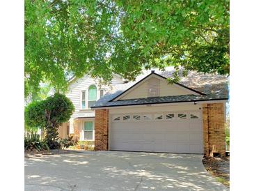 Charming two-story home with a brick-accented two car garage and well manicured landscaping at 983 Bucksaw Pl, Longwood, FL 32750