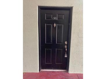 Close-up of a black door with a knocker and security lock at 2007 Dixie Belle Dr # 2007 M, Orlando, FL 32812