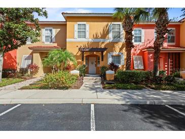 Charming multi-colored townhouse with lush landscaping and inviting front entrance at 2742 Sun Key Pl, Kissimmee, FL 34747