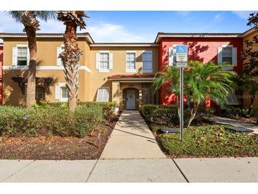 Charming townhome with lush landscaping and a convenient accessible parking space at 2756 Sun Key Pl, Kissimmee, FL 34747