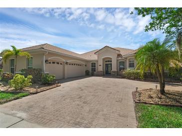 Charming single-story home featuring a tile roof, manicured landscaping, and a spacious three-car garage at 2801 Boat Cove Cir, Kissimmee, FL 34746