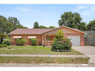Charming single-story home with a well-maintained front yard and attached garage at 2933 N Chickasaw Trl, Orlando, FL 32817