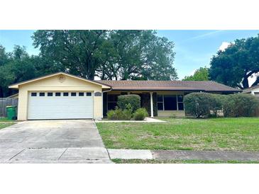 Charming single-story home featuring a two-car garage and a well-maintained lawn with mature landscaping at 4105 Quando Dr, Belle Isle, FL 32812