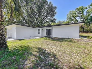Charming single-story home with a well-maintained lawn and modern exterior at 43 Lake Court Loop, Ocala, FL 34472
