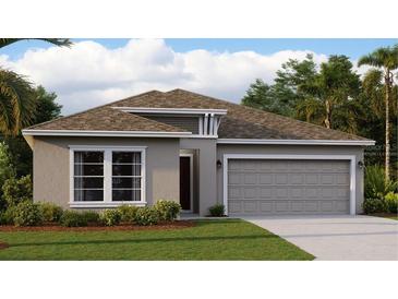 Charming single-story home features a two-car garage, manicured lawn, and thoughtfully designed front elevation at 7546 Headwaters Ct, Groveland, FL 34736