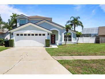 Charming two-story home featuring an attached garage and well-manicured lawn at 11836 Hartfordshire Way, Orlando, FL 32824