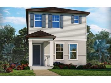Charming two-story home with a well-manicured lawn and inviting front porch, complemented by colorful landscaping at 14244 Braemar St, Winter Garden, FL 34787