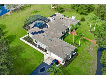 Expansive aerial view of a home featuring a screened pool, solar panels, lush landscaping, and a long driveway at 2326 Florida Ave, Oviedo, FL 32765