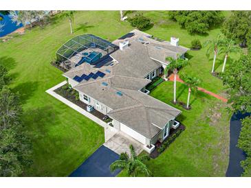 Stunning aerial view of a spacious single-story home with a screened pool, solar panels, and lush landscaping at 2326 Florida Ave, Oviedo, FL 32765