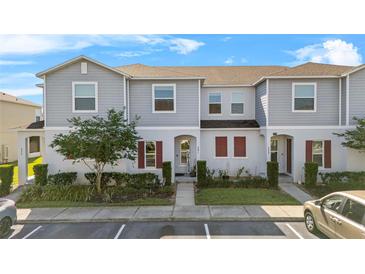 Charming two-story townhome with well-maintained landscaping and a welcoming facade at 281 Primrose Dr, Davenport, FL 33837