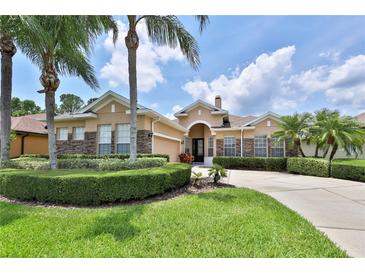 Beautiful single-story home showcasing well-manicured landscaping and a welcoming circular driveway at 5154 Majestic Woods Pl, Sanford, FL 32771
