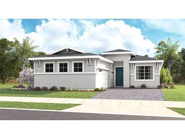 Charming single-story home featuring a brick paved driveway, manicured lawn, and tropical landscaping at 944 Club Cresswind Dr, Lady Lake, FL 32159