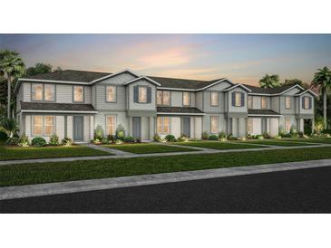 Charming townhome showcases neutral siding, a well-manicured lawn, and lush landscaping enhancing its curb appeal at 10148 Hadley St, Orlando, FL 32829