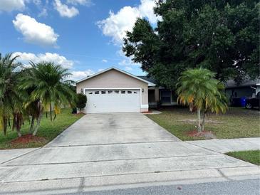 Charming single-story home with a two-car garage and well-maintained lawn at 1614 Christa Ct, St Cloud, FL 34772