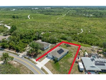 A captivating aerial view of the property showcasing the house with solar panels and expansive lot at 2135 E Old Mill Dr, Deltona, FL 32725