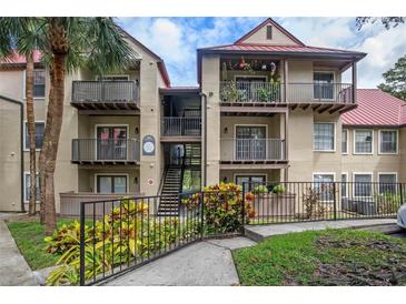 Inviting condo exterior with balconies, lush landscaping, and convenient stair access at 238 Afton Sq # 106, Altamonte Springs, FL 32714