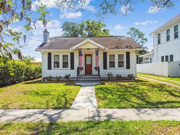 Charming home featuring a landscaped front yard, sidewalk and a quaint exterior at 2505 Amherst Ave, Orlando, FL 32804