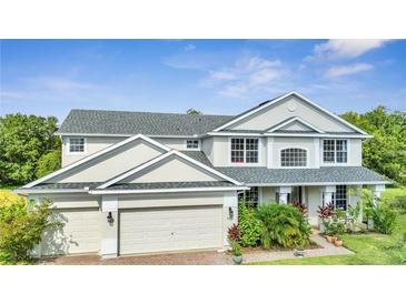 Charming two-story home featuring a three-car garage and well-maintained landscaping at 4394 Devon Ct, Kissimmee, FL 34746