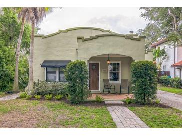 Charming stucco home with a brick walkway, covered porch, and lush landscaping at 1012 W New Hampshire St, Orlando, FL 32804
