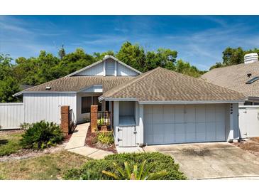 Charming single-story home featuring a two-car garage, mature trees, and a well-maintained front yard at 2652 Bent Hickory Cir, Longwood, FL 32779