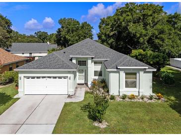 Charming single-story home featuring a well-manicured lawn and attached two-car garage at 2710 Autumn Ln, Eustis, FL 32726