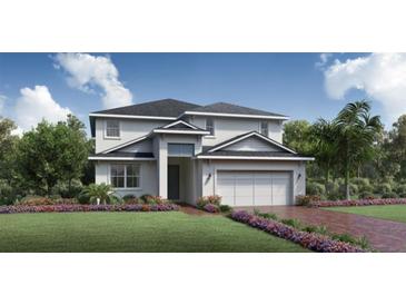 Charming two-story home with a manicured lawn, colorful flower beds, and an attached two-car garage at 2715 Arbor Dune Ave, Apopka, FL 32712
