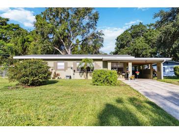Charming single-story home with a well-maintained lawn and a covered carport at 3118 Walnut St, Winter Haven, FL 33881