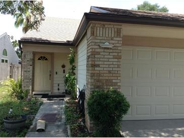 Charming single-story home featuring a brick facade, attached garage, and well-maintained landscaping at 3312 Bridgeford Dr, Orlando, FL 32812