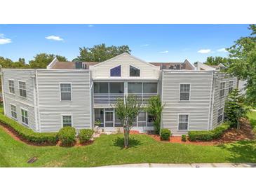 Charming condo featuring a screened porch and manicured lawn, perfect for relaxing outdoors at 3900 Southpointe Dr # 127, Orlando, FL 32822