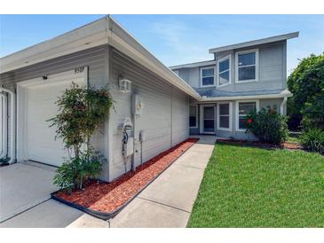 Charming two-story home featuring a well-maintained front yard and an attached garage at 950 Vanessa Ct # F, Port Orange, FL 32127