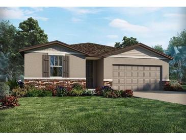 Charming single-story home featuring stone accents, a two-car garage, and a beautifully landscaped front yard at 1737 Forest Run Ln, Auburndale, FL 33823
