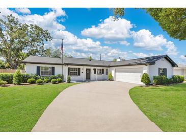 Charming single-story home with a long driveway, well-manicured lawn, and neat landscaping at 2460 Worthington Rd, Maitland, FL 32751