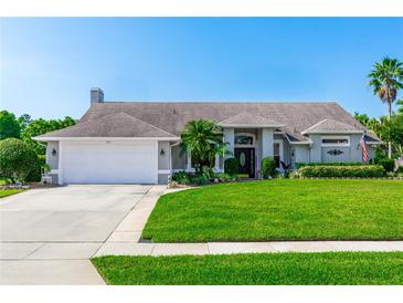 Charming single-story home with a well-manicured lawn and a two-car garage at 341 Sprucewood Rd, Lake Mary, FL 32746