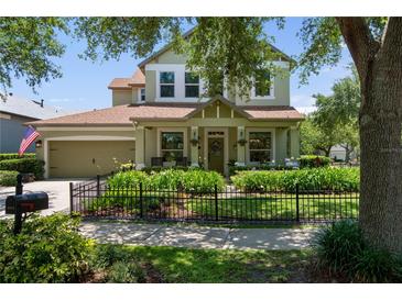 Charming two-story home featuring a landscaped front yard and inviting front porch at 402 S Lake Victoria Cir, Deland, FL 32724