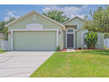 Charming single-story home with a well-manicured lawn and an attached two-car garage at 12020 Philbrook Ct, Orlando, FL 32825